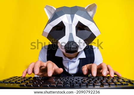Portrait of crazy bizarre marketer racoon mask identity write letter pc device prepare project isolated over yellow color background