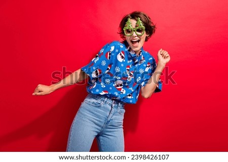 Portrait of crazy cheerful lady newyear glasses enjoy dancing chilling isolated on vibrant red color background