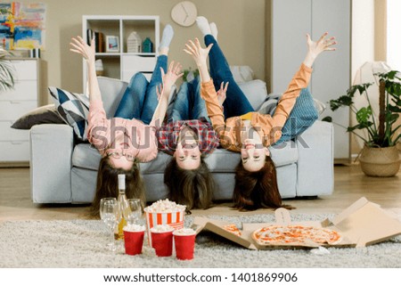 Similar – Image, Stock Photo Young woman lying upside down on an armchair
