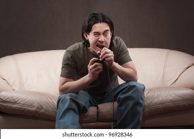 Portrait Of A Crazy Gamer On Gray Background