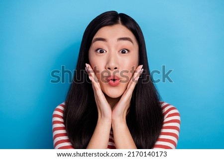 Portrait of crazy impressed indonesian person arms touch cheeks pouted lips isolated on blue color background
