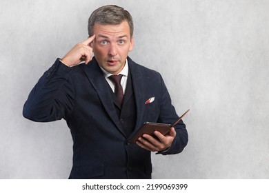 Portrait Of A Crazy Man With A Gadget In His Hand.Getting Strange Unusual News On The Internet. Man On A White Isolated Background.