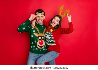 Portrait of crazy two people wife husband student hipster hug embrace wear brown comfort cozy pullover sweater with chritsmas tree design denim jeans eyewear isolated over red color background - Shutterstock ID 1502293352