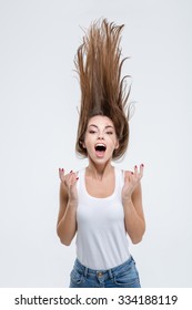 Portrait Of A Crazy Woman With Hair Up Into Air Isolated On A White Background