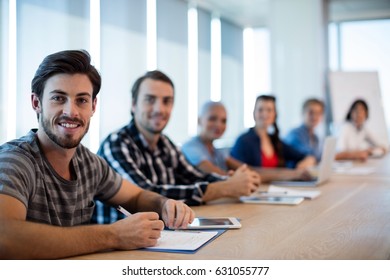 Portrait of creative business team sitting in the conference room at office - Shutterstock ID 631055777