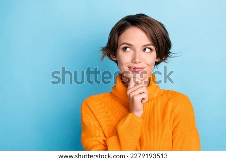 Portrait of creative gorgeous person arm touch chin look empty space brainstorming isolated on blue color background Foto stock © 