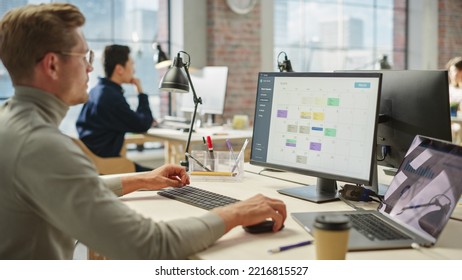 Portrait of Creative Young Man Consulting Using Computer and Laptop. White Male Supervisor Working on Scheduling Using Project Management Software. - Shutterstock ID 2216815527