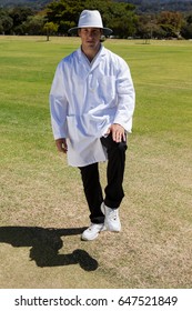 Portrait Of Cricket Umpire Signaling Leg Bye On Sunny Day During Match