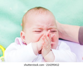 Portrait Of A Crying Baby Because She Is Teething