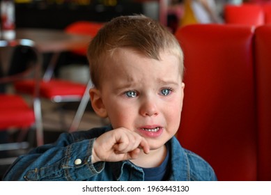 Portrait Of A Crying Baby. The Child Is Very Upset. Close-up