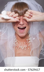 portrait of crying bride over grey background