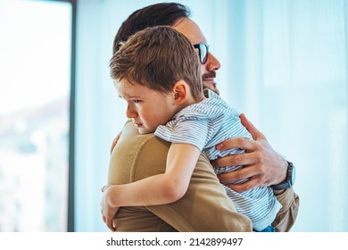 Portrait of a crying child on hands a father. Little boy crying on father's shoulder. Father and Son Together. Close up of small boy crying in his father's hug at home.  - Shutterstock ID 2142899497