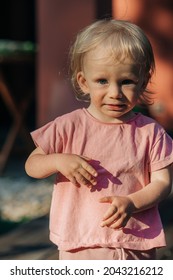 Portrait Of Crying Toddler Girl Standing Outdoors. Cute Little Child Wearing Pink Tshirt. Childhood Concept