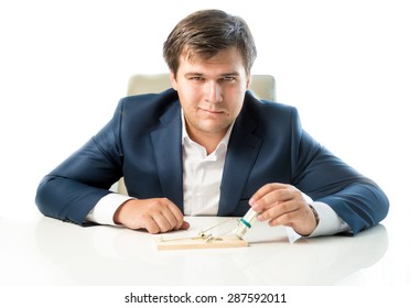 Portrait Of Cunning Businessman Putting Money In Trap As Lure