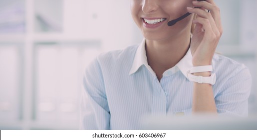 portrait of a customer service agent sitting at office - Shutterstock ID 603406967