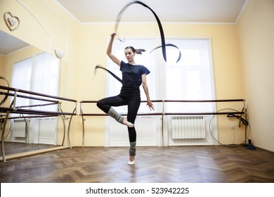 Portrait of cut Pretty rhythmic gymnast girl exercising with ribbon - Powered by Shutterstock