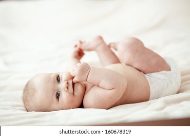 Portrait of a cute 3 months baby lying down on a blanket