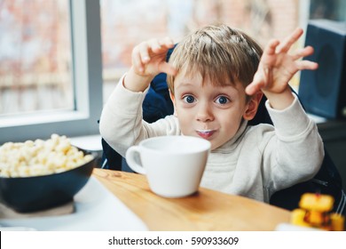 Portrait Of Cute Adorable Caucasian Child Kid Boy Drinking Milk From White Cup Eating Breakfast Lunch Early Morning, Everyday Lifestyle Candid Moments