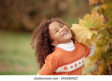 Portrait of cute adorable little  girl child making funny silly faces, showing tongue, in autumn fall park outside, playing having fun, lifestyle childhood