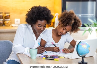 Portrait Of Cute African Girl Using Laptop With Mom, Homeschooling And Remote Education Concept. Mother Helping Teenager With Homework. Happy Girl With Mother Studying Online At Home 