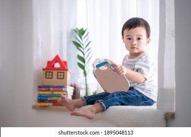 Portrait cute Asian baby boy reading a book,Baby early education,Child development concept. - Powered by Shutterstock