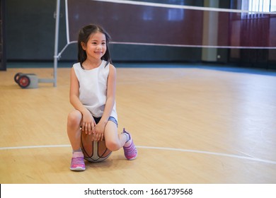 Portrait cute asian little child girl playing basketball