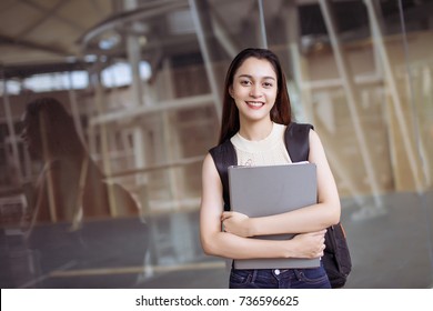 portrait of cute Asian teen, female high school student aboard relax smile with backpack and folder holding, with copy space.