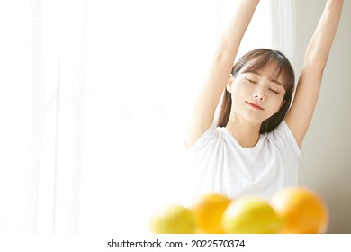 Portrait Of Cute Asian Woman With Fruits