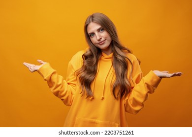 Portrait Of Cute Attractive Young Woman Showing Whatever Gesture On Yellow Background