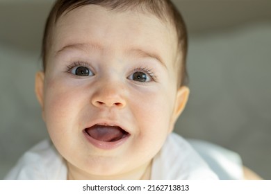 portrait of cute baby boy with 2 teeth up and down.teething period of toddlers. big beautiful eyes and long eyelashes. motherhood concept.