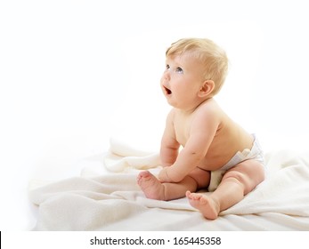 Portrait of cute baby boy look up sitting on plaid, adorable child closeup