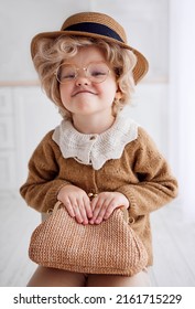 Portrait Of Cute Baby Girl Cosplaying A Grumpy Old Lady. Carnival Costume Party