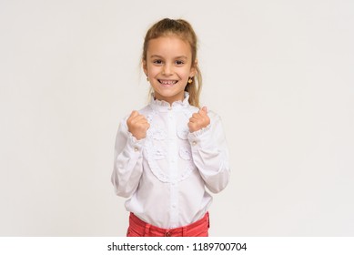 Portrait Of A Cute Baby Girl On A White Background. The Child Is Right In Front Of The Camera, Smiling And Looking Happy