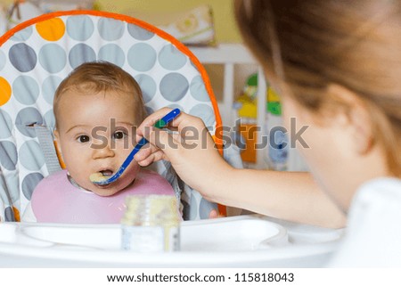 Similar – Mother with eating toddler.