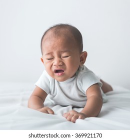 Portrait Of A Cute Baby Sneezing While Tummy Time