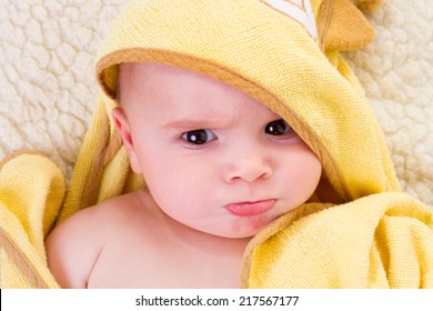 portrait of cute baby in yellow towel