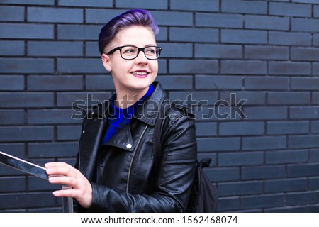 Portrait of cute beautiful young lesbian with short haircut and trendy boyish clothes