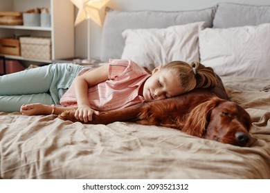 Portrait Of Cute Blonde Girl Sleeping With Big Dog On Bed, Copy Space