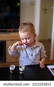 Portrait Of Cute Boy Eating Dessert With A Spoon