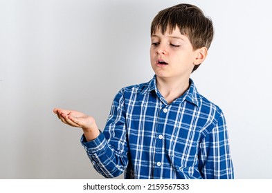 Portrait Of Cute Boy Holding Nothing - Side View. Happy Kid With Empty Palm Up - Profile, Isolated Over White Background. Child Stretched Out His Hands - Advertising Area