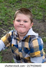 Portrait Of A Cute Boy Outside With A Smug Grin