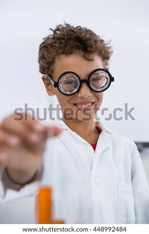 Similar – Happy kid looking at camera through magnifying glass