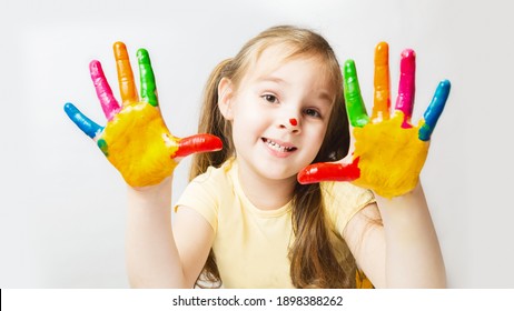 Portrait Cute Caucasian Preschool Little Girl With Face And Hands Painted At Home