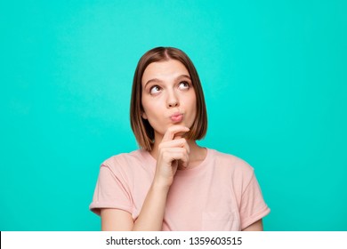 Portrait of cute charming lady think future have problems decide solve choose beautiful touch chin hand fingers look up wear pink colored modern clothing isolated on turquoise background