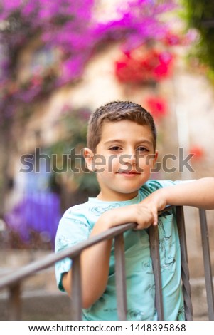 Similar – Cute little boy seated on the wall of a castle