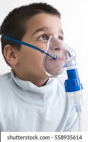 Portrait Of Cute Child Using Asthma Inhaler Isolated On White Background   