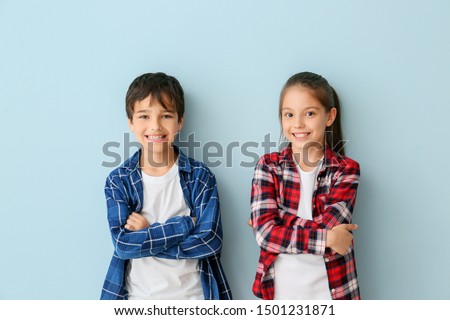 Portrait of cute children on color background