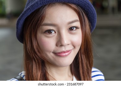 Portrait Of Cute Chinese Girl In A Knitted Cap