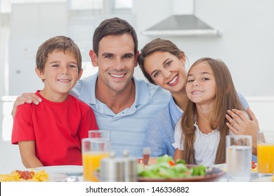 Portrait Of A Cute Family At The Table