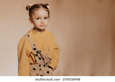 Portrait Of A Cute Funny Girl With A Beautiful Hairstyle And Stylish Clothes On A Solid Background